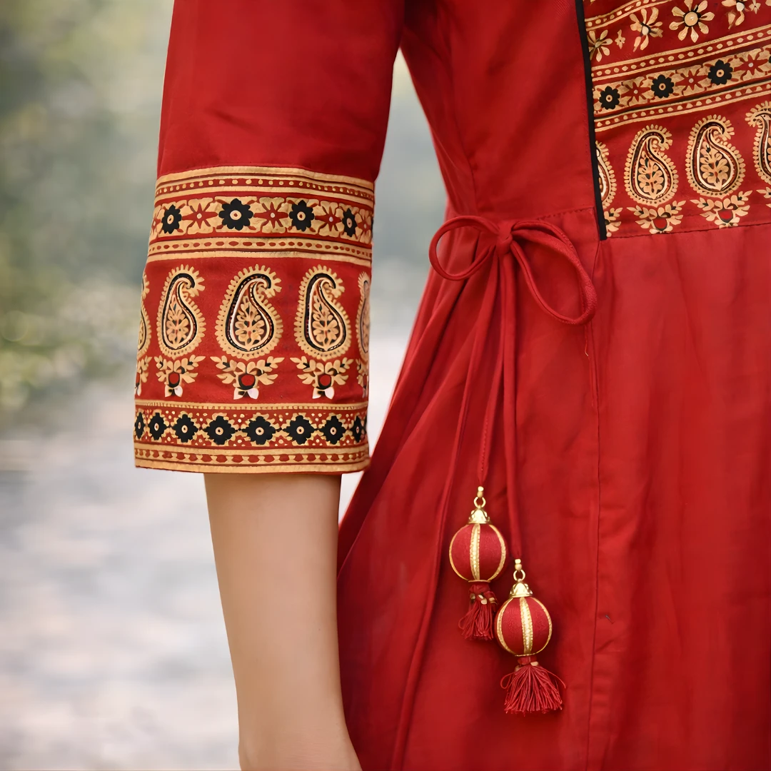 Red frock suit sleeve border and tassel detail.